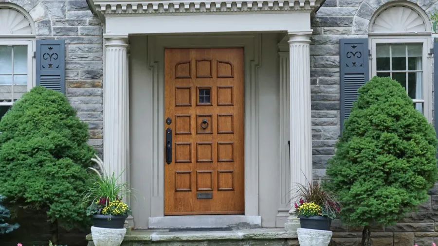 portico front door entrance of older stone faced house with