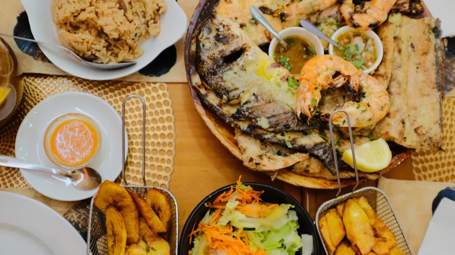 portuguese grilled seafood platter with prawns sardines lemon wedges fries