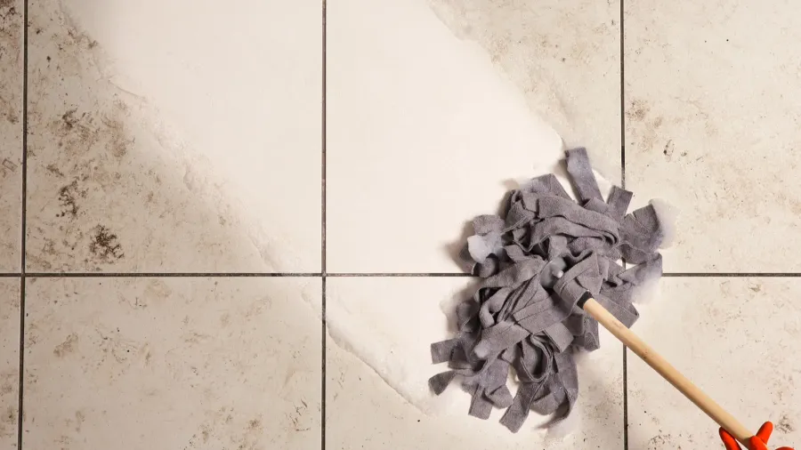 Top view of cleaning a dirty floor using mop