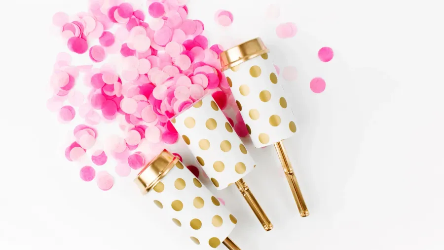 push confetti poppers on white background close up view