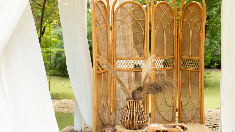 rattan vase with bouquet of dried floral spikelets ears and