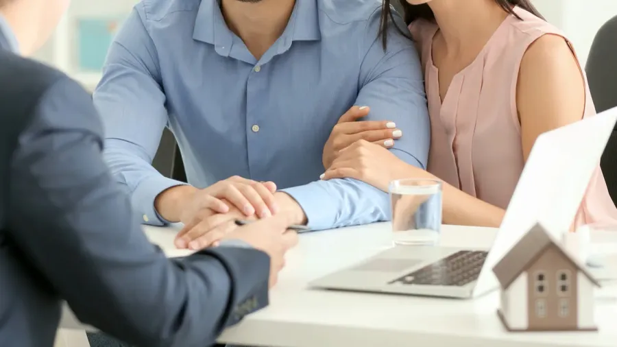 real estate agent working with clients in office