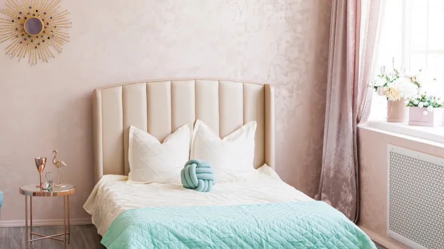 real photo of a bright bedroom in pink blue