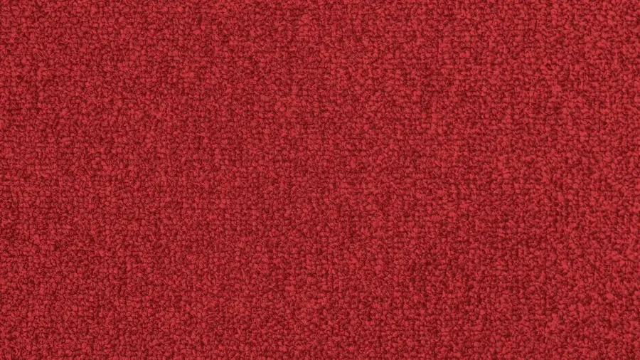 A close-up of a soft red fabric or carpet showing its textured surface.