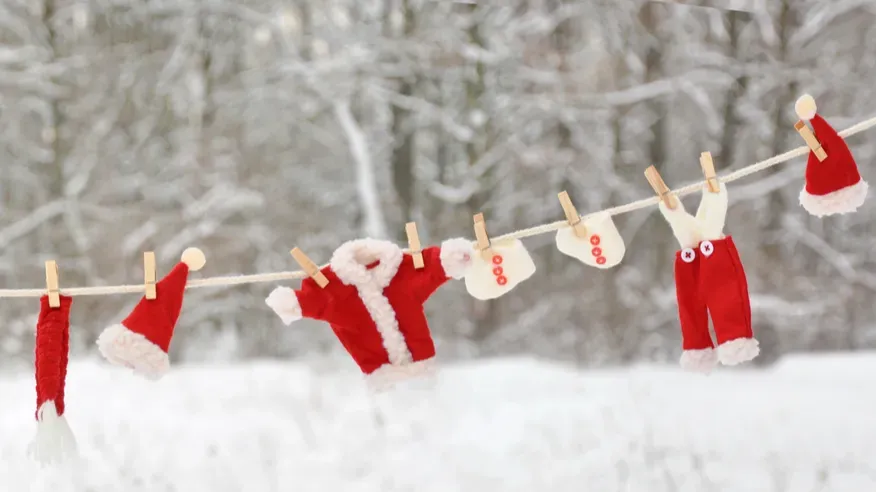 red santa claus clothes drying in the open air hanging