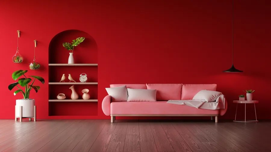 Vibrant red living room with a pink sofa and plants.