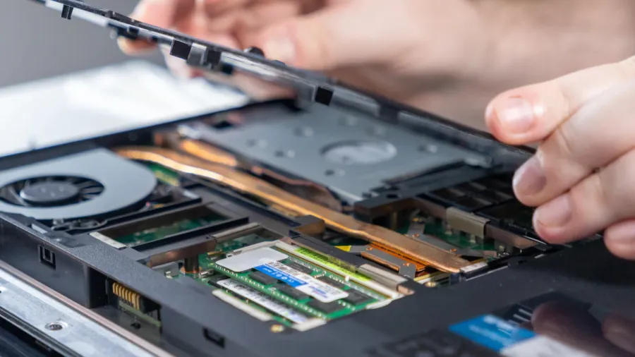 removing laptop back panel to expose internal components showcasing ram