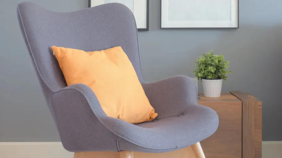 retry style armchair with orange pillow in living room with