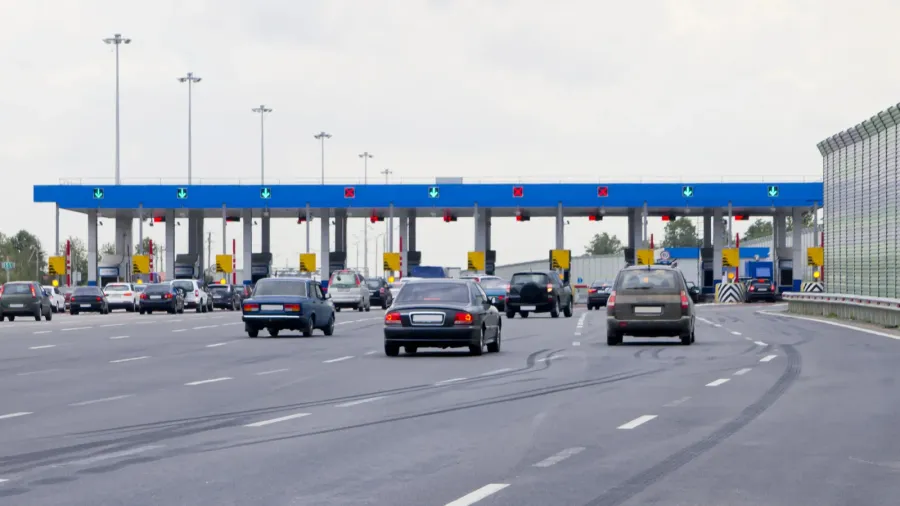 road tollgate with barriers by toll road on the highway