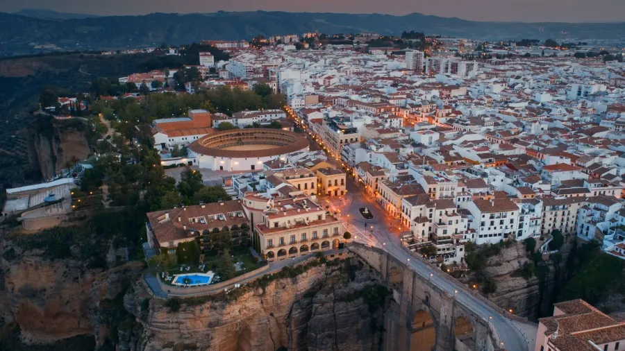 ronda aerial view at sunrise with old buildings in spain