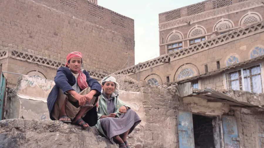 sanaa yemenapril 252011 two men sitting on a rock in