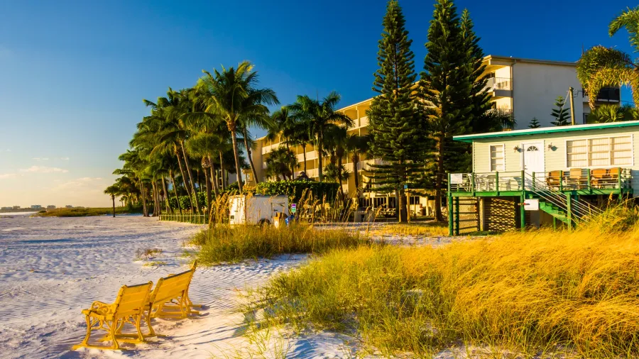 sand dunes and buildings on the beach in fort myers