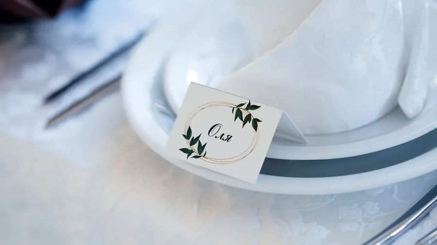 A close-up of a table setting with a name tag on a plate.