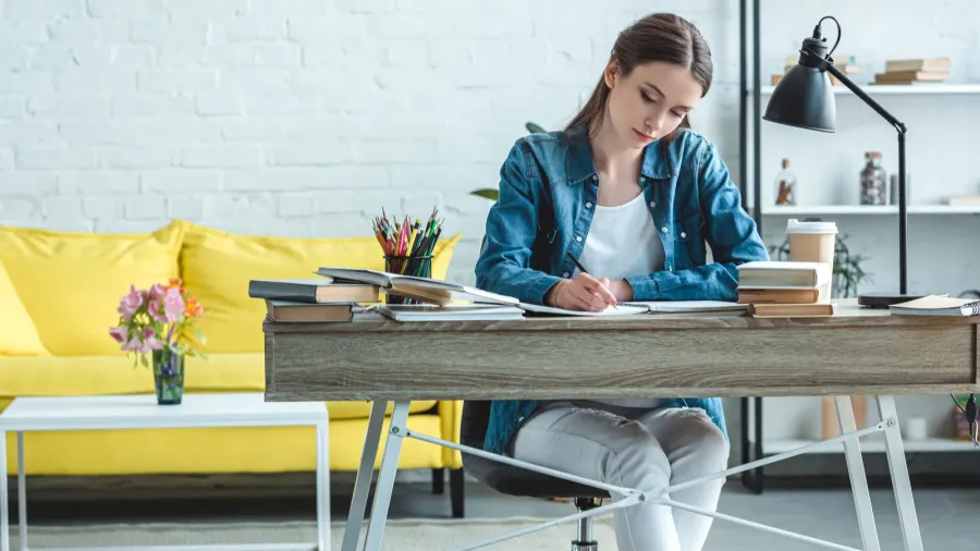 selective focus of focused girl taking notes and studying at