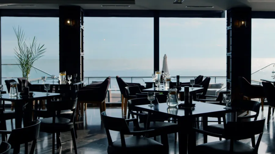 served lunch tables in spacious stylish cafeteria with beautiful sea
