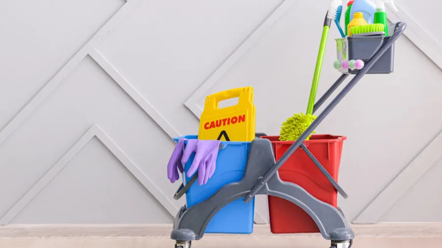 set of cleaning supplies near grey wall