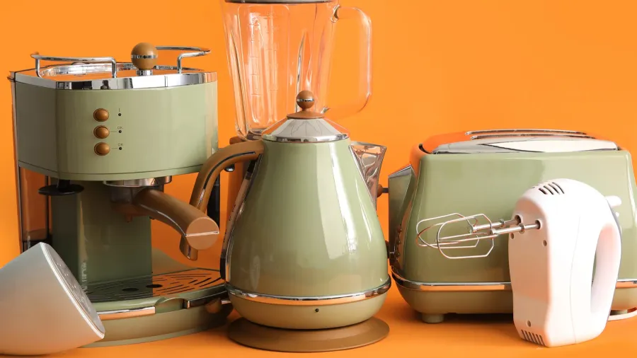 set of modern household appliances on orange background