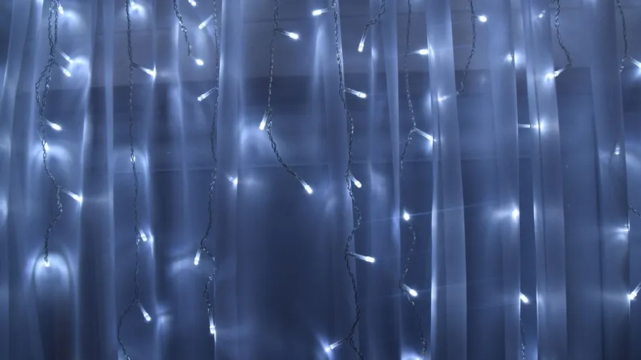 White string lights draped over sheer curtains.