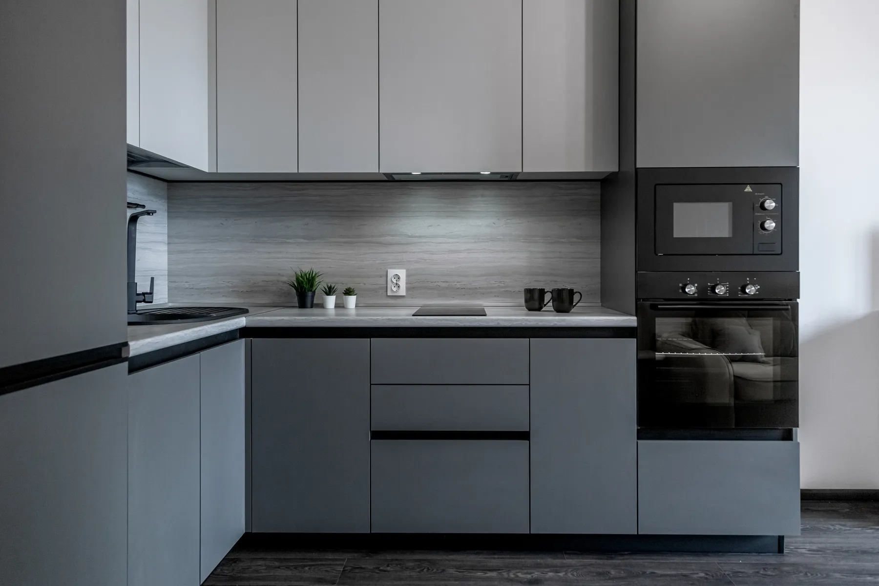 A vibrant kitchen displays light gray cabinets, a blue wall, and a red accent island with a wooden countertop.