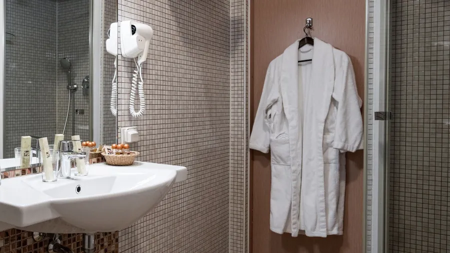 Bathroom interior in beige color with a over-the-door hook.