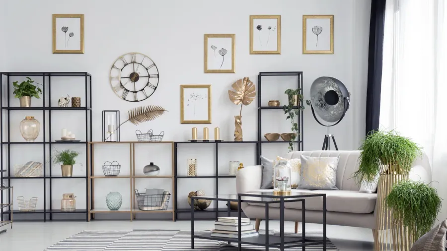 Bright, contemporary living space with a white sofa, stylish shelving, and decor accents.