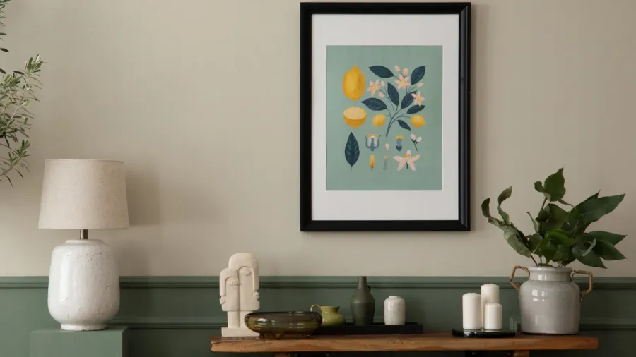 A cozy corner with a decorative lamp, a green plant, and a framed botanical print.