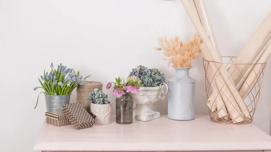 spring mood. Vintage interior decoration. pink pastel closet. Dry anf fresh flowers on wooden table. A large clock on a white wall. copy space