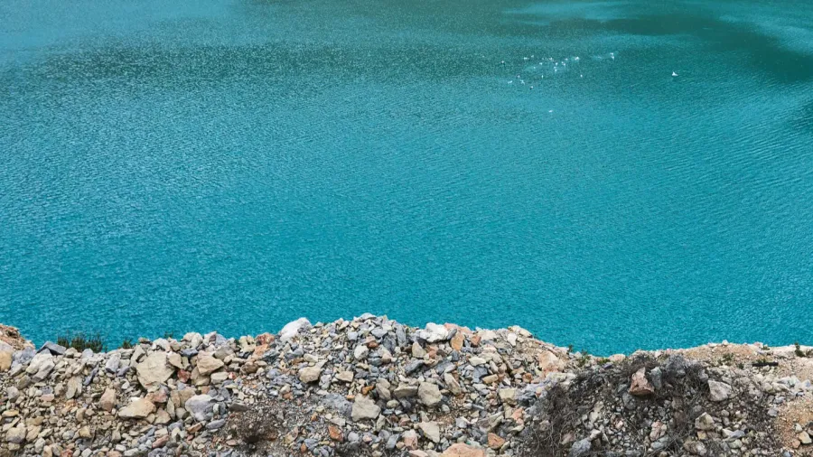stepped slopes of an old limestone quarry with a blue