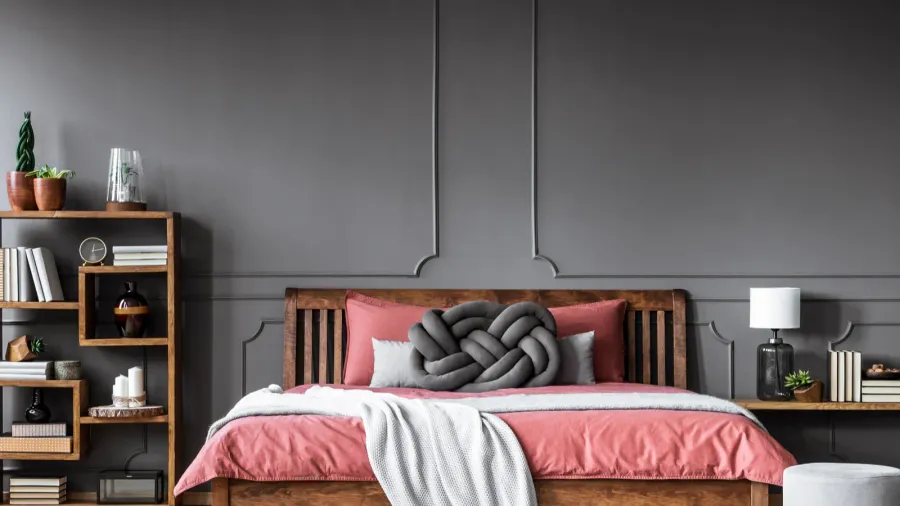 stool next to pink wooden bed in grey modern bedroom