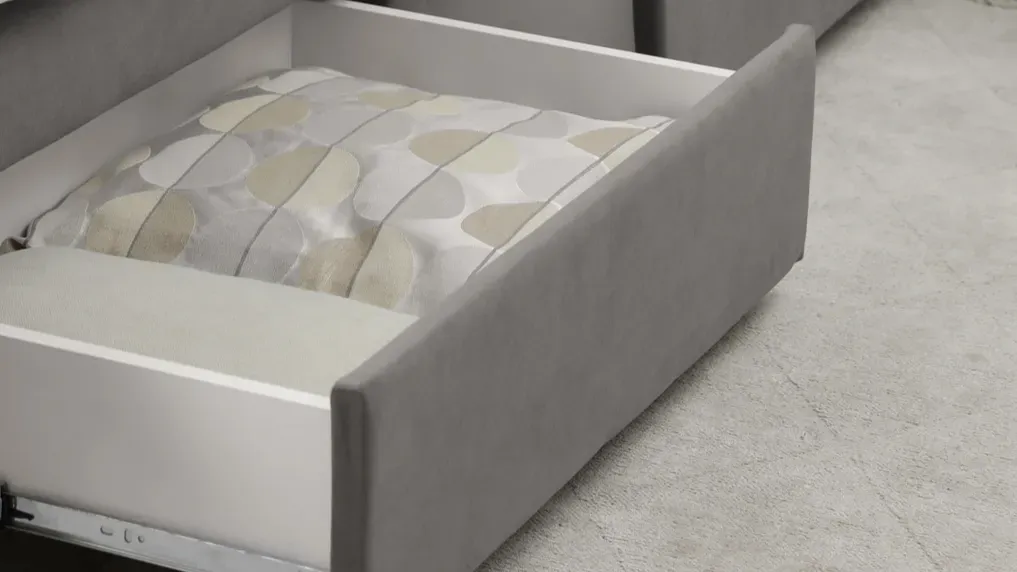 An under-the-bed storage drawer with bedding.