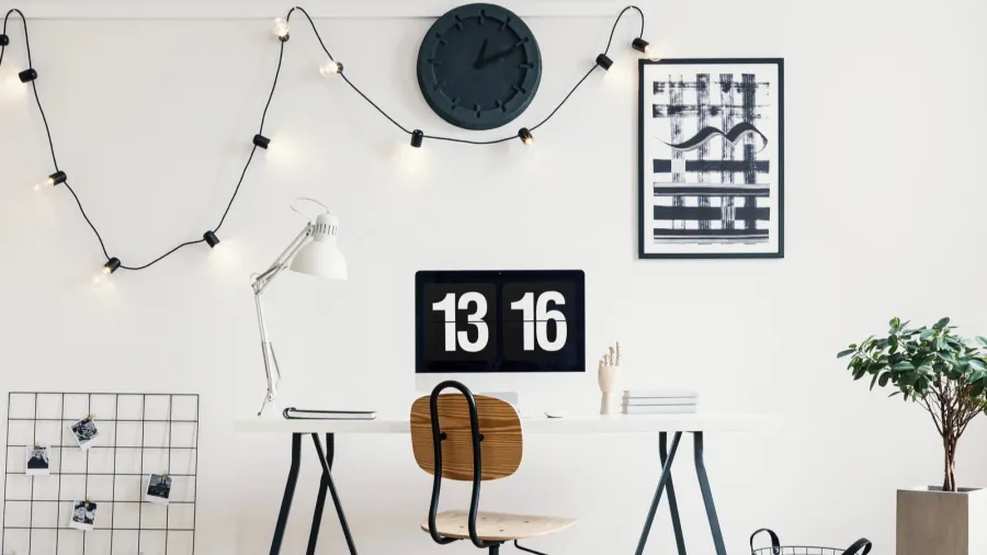 string lights with bulbs on a white wall in a