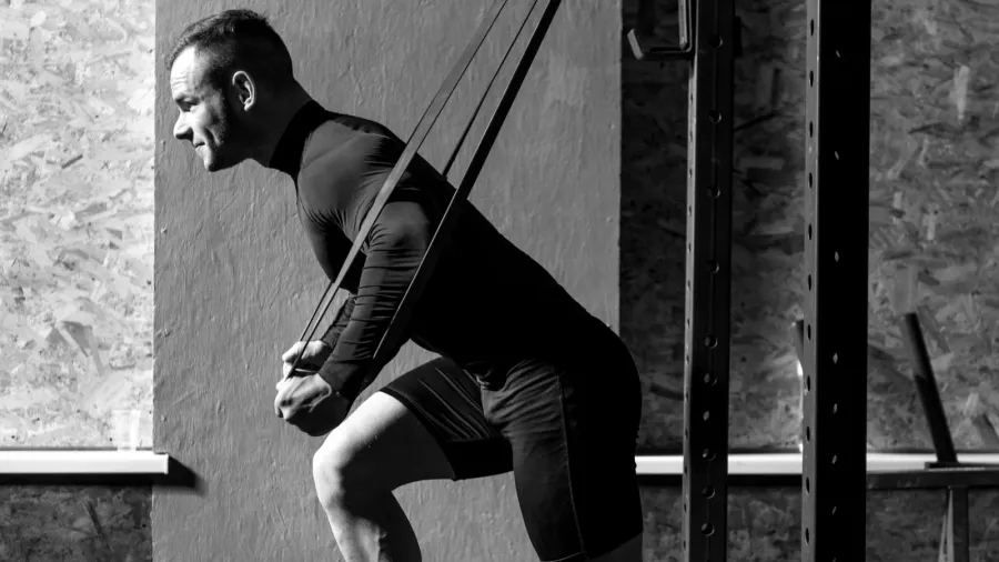 strong confident man exercising in a gym