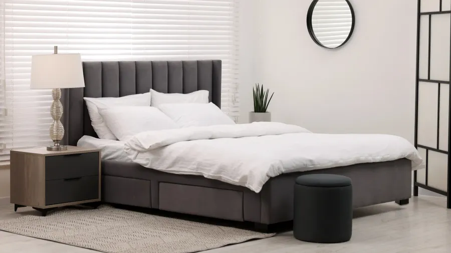 stylish bedroom interior with large bed chest of drawers and