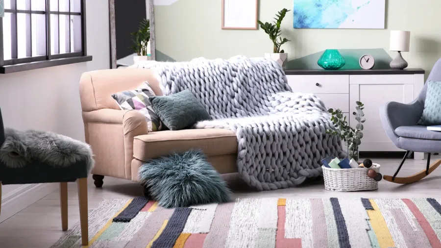 stylish living room interior with comfortable sofa and rocking chair