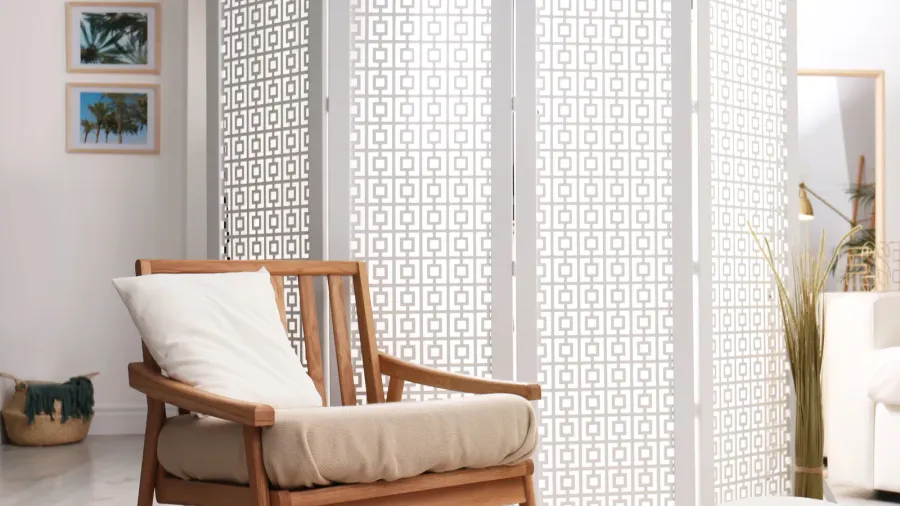 stylish room interior with white folding screen and armchair
