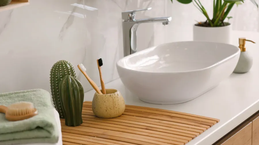 stylish vessel sink on light countertop in modern bathroom