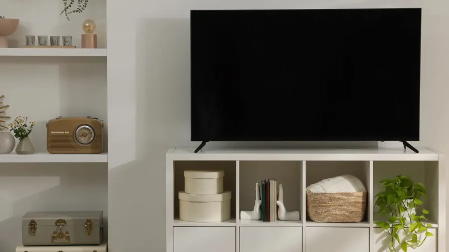 stylish wide tv set on stand in room