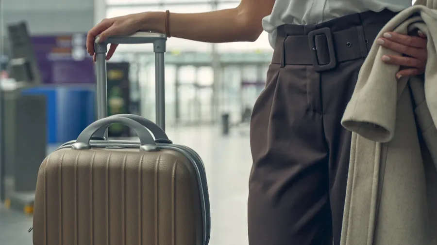 stylish young woman spending morning in the airport