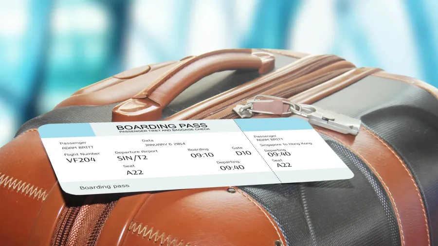 suitcase and boarding pass at the airport