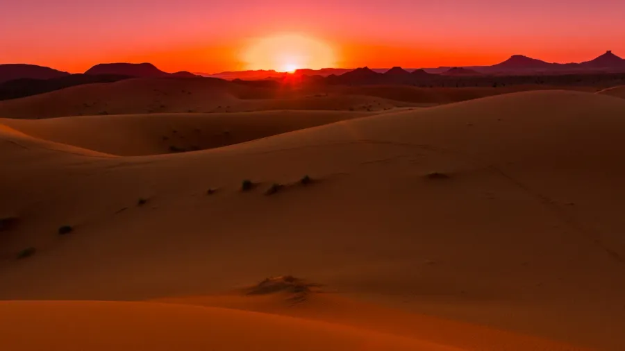 sunset in the dunes of erg chebbi morocco