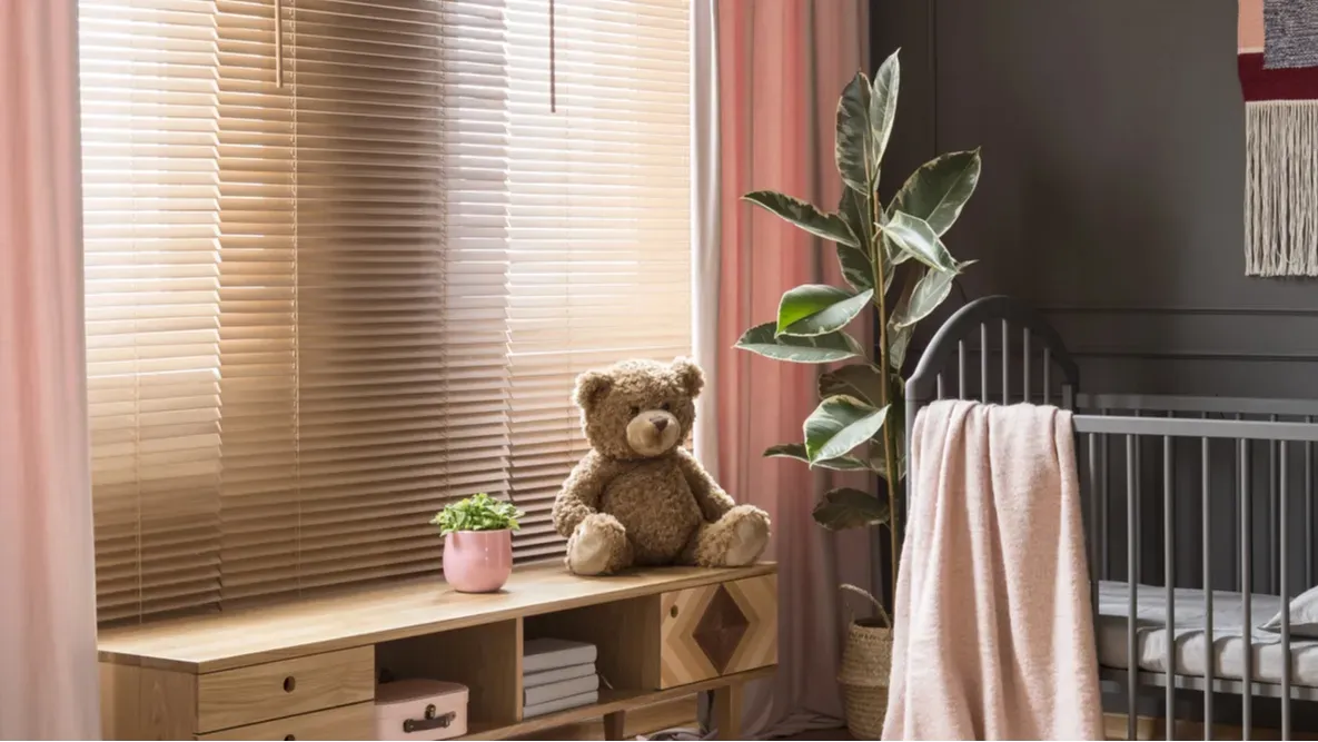 sweet pastel pink accessories in a classic dark nursery bedroom