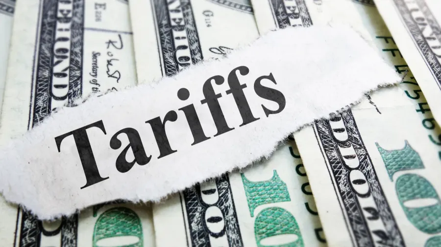 tariffs newspaper headline on money