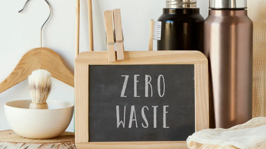 the text zero waste in a chalkboard and a pile