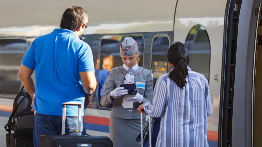 the train hostess checks the tickets and documents while boarding