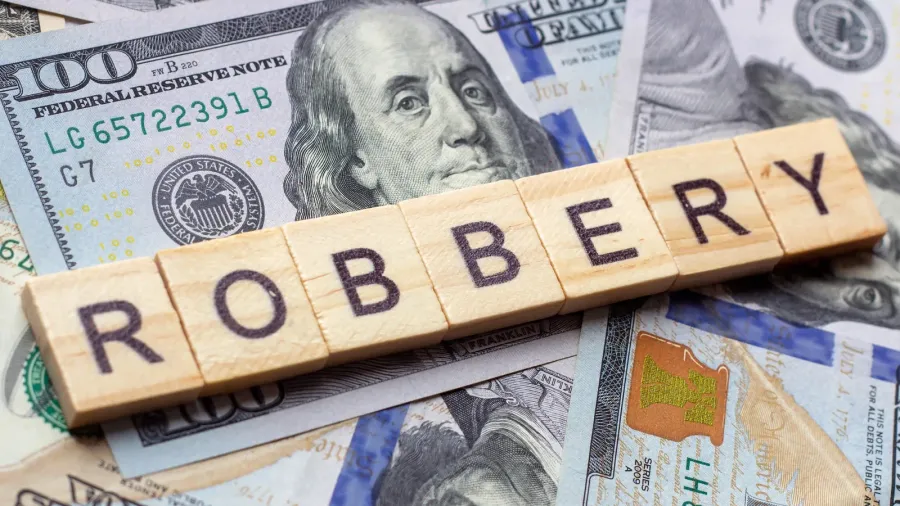 the word robbery on dollar usa background theft and stealing
