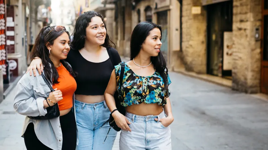 three young women walking and hanging out on a comercial