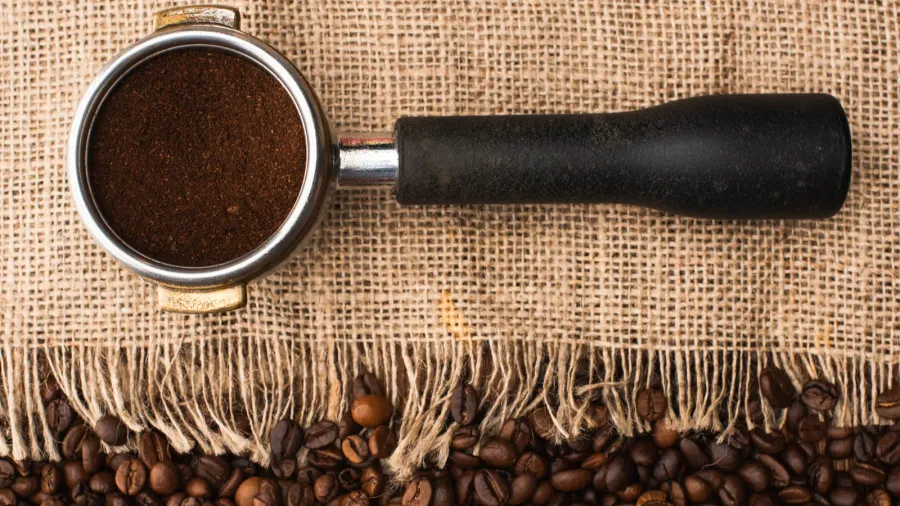 top view of fresh roasted coffee beans and sackcloth with