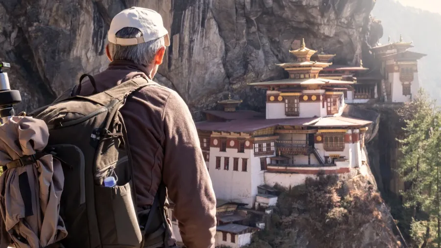 tourist sitting on his back watching tigers nest temple in