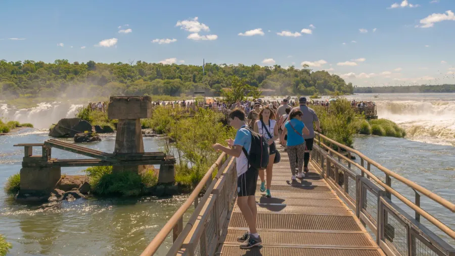 tourists at birdge in parana river at iguazu falls