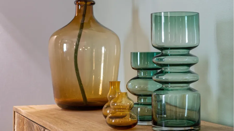 transparent yellow and green vases for flowers and big bottle